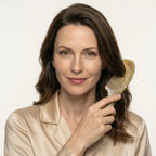 An elegant woman using a Cozuy comb for frizzy hair during her daily routine to help smooth flyaways.