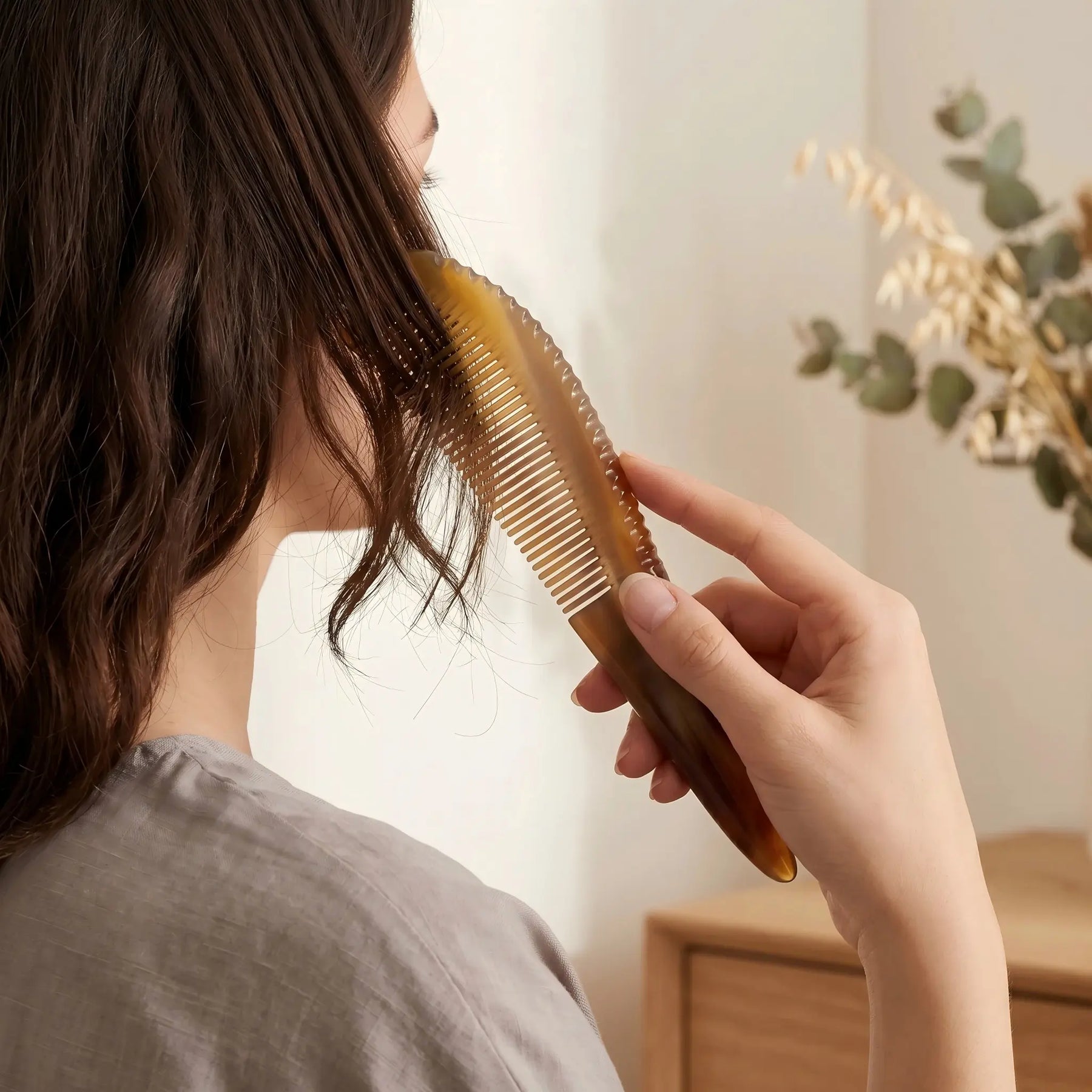 COZUY amber ox horn pointed-tail comb gently combing dark hair in a daily hair-care routine. detail image 5