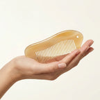 Close-up of a Cozuy anti frizz comb highlighting gentle rounded teeth that massage the scalp.