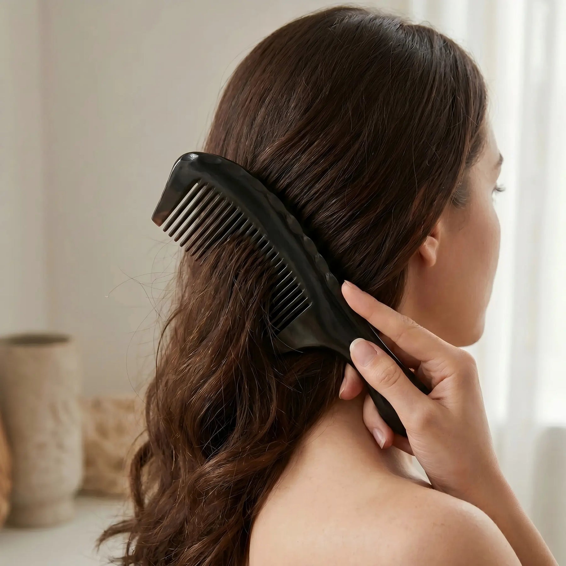 COZUY black ox horn rounded-handle comb gently combing dark hair in a daily hair-care routine. detail image 5