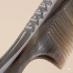A Cozuy buffalo horn comb held gently in hands, serving as a mindful self care gift for women to help reduce frizz.