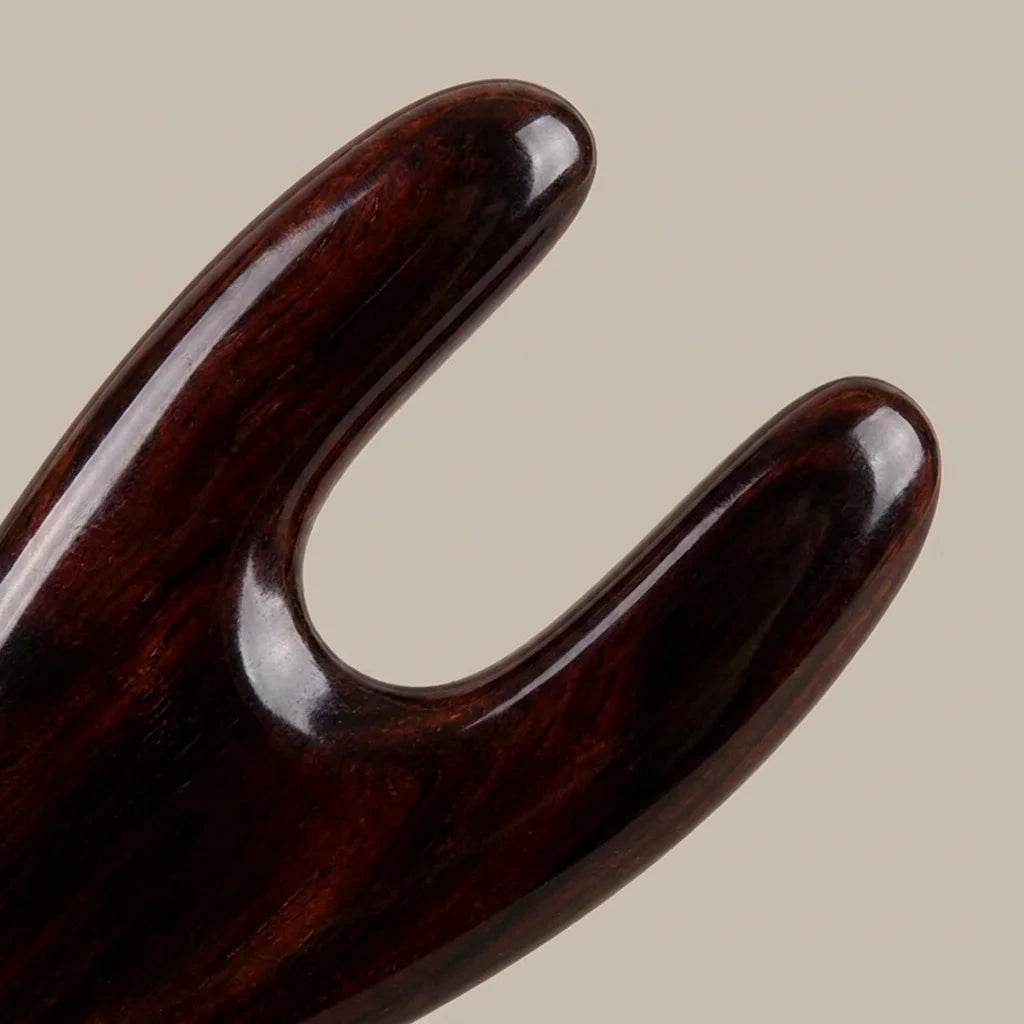 Close-up of a hand-polished Cozuy buffalo horn hair accessory highlighting gentle rounded teeth to massage the scal