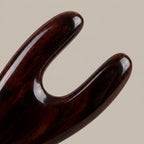 Close-up of a hand-polished Cozuy buffalo horn hair accessory highlighting gentle rounded teeth to massage the scal