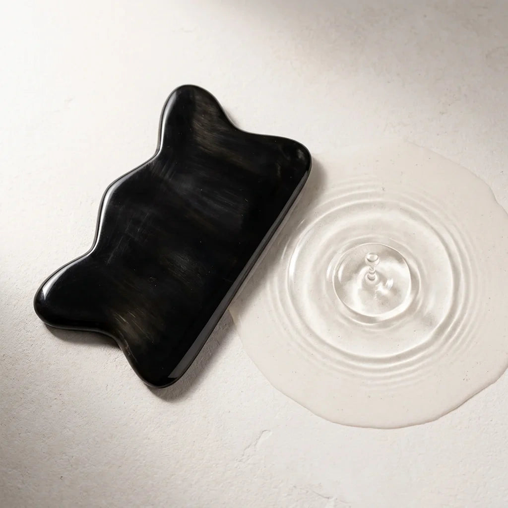 A Cozuy buffalo horn hair accessory resting by clear water ripples, perfect for a mindful self care ritual.