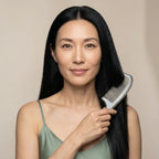 An elegant woman using a Cozuy comb for frizzy hair during her daily routine to help smooth flyaways and reduce static.