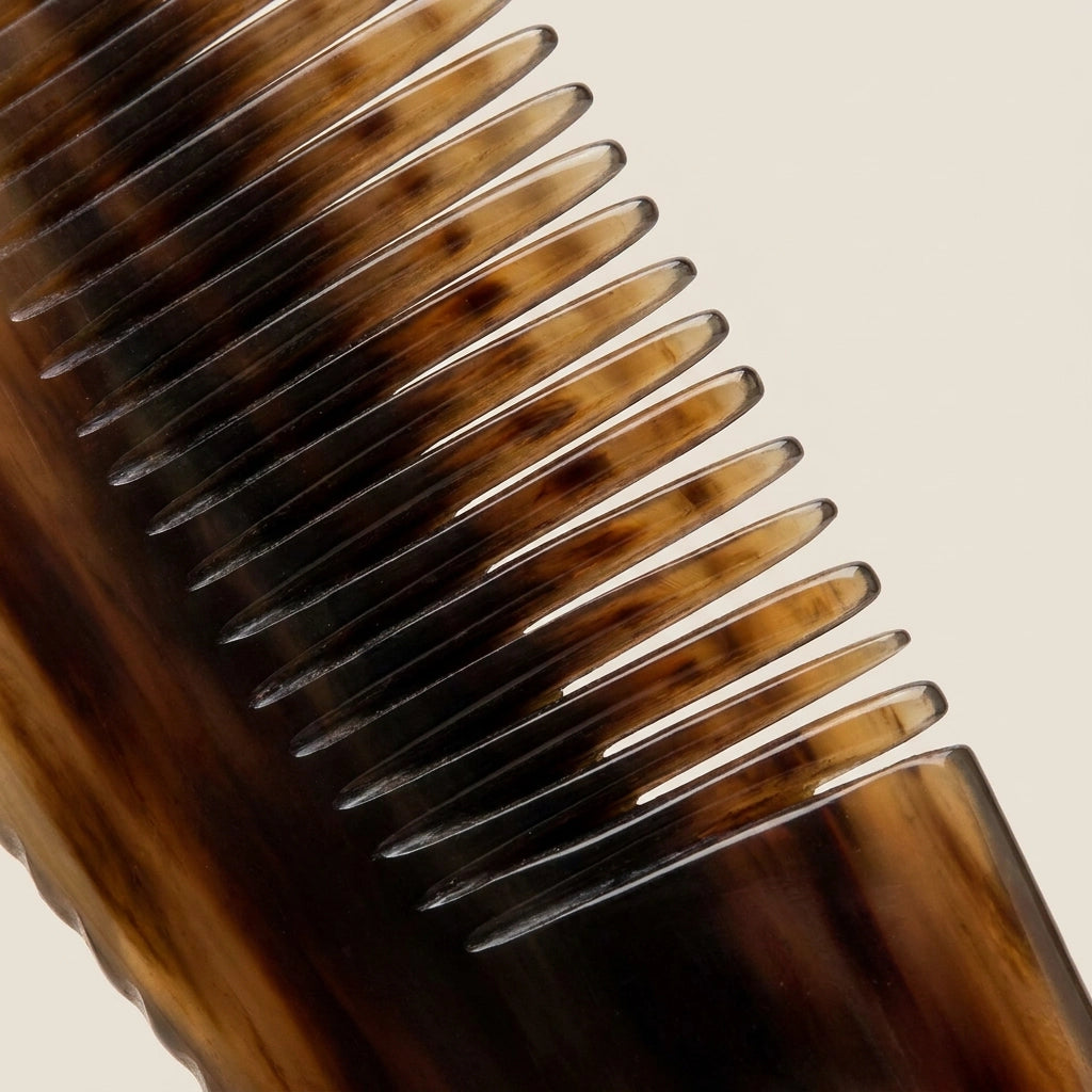 Extreme close-up of translucent natural horn comb teeth, crafted for gentle scalp micro-circulation.