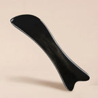 A Cozuy natural beauty tool floating on a beige background, designed for a gentle massage and mindful self care.