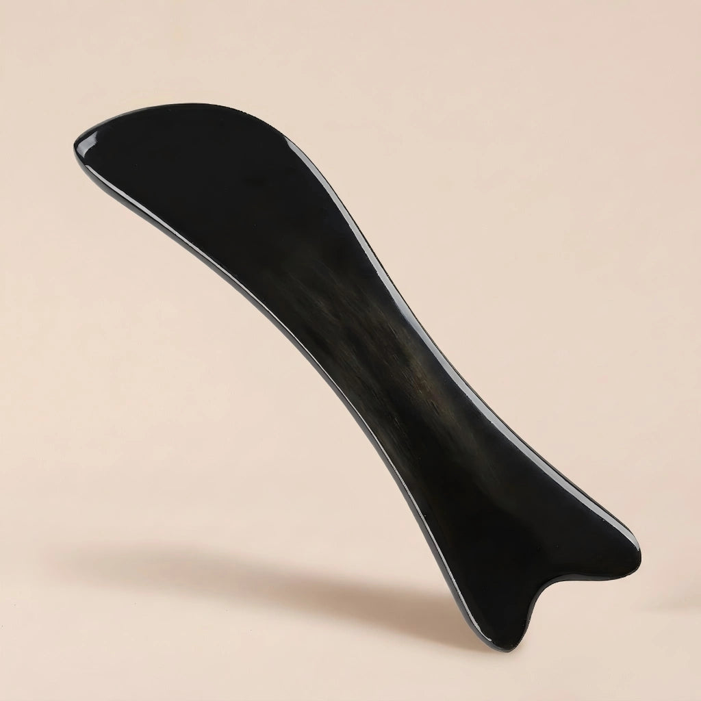 A Cozuy natural beauty tool floating on a beige background, designed for a gentle massage and mindful self care.