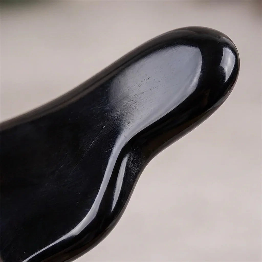 Close-up of a Cozuy buffalo horn hair accessory highlighting its smooth hand-polished surface  for massage.
