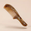 A translucent Cozuy natural horn comb floating on a beige background, designed to help reduce static and smooth flyaways.