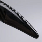 A Cozuy natural horn comb held gently in hands, serving as a mindful self care gift for women.