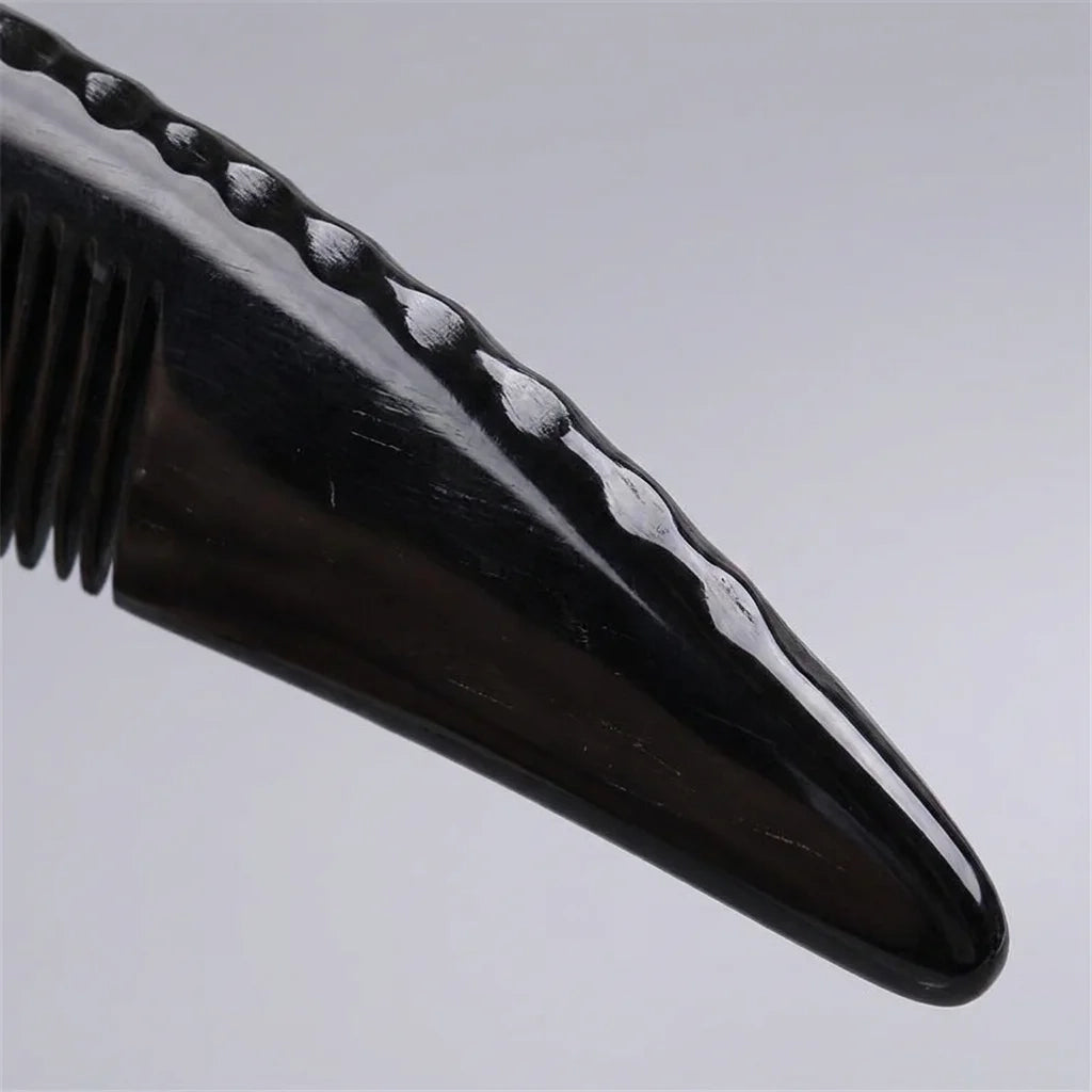 A Cozuy natural horn comb held gently in hands, serving as a mindful self care gift for women.