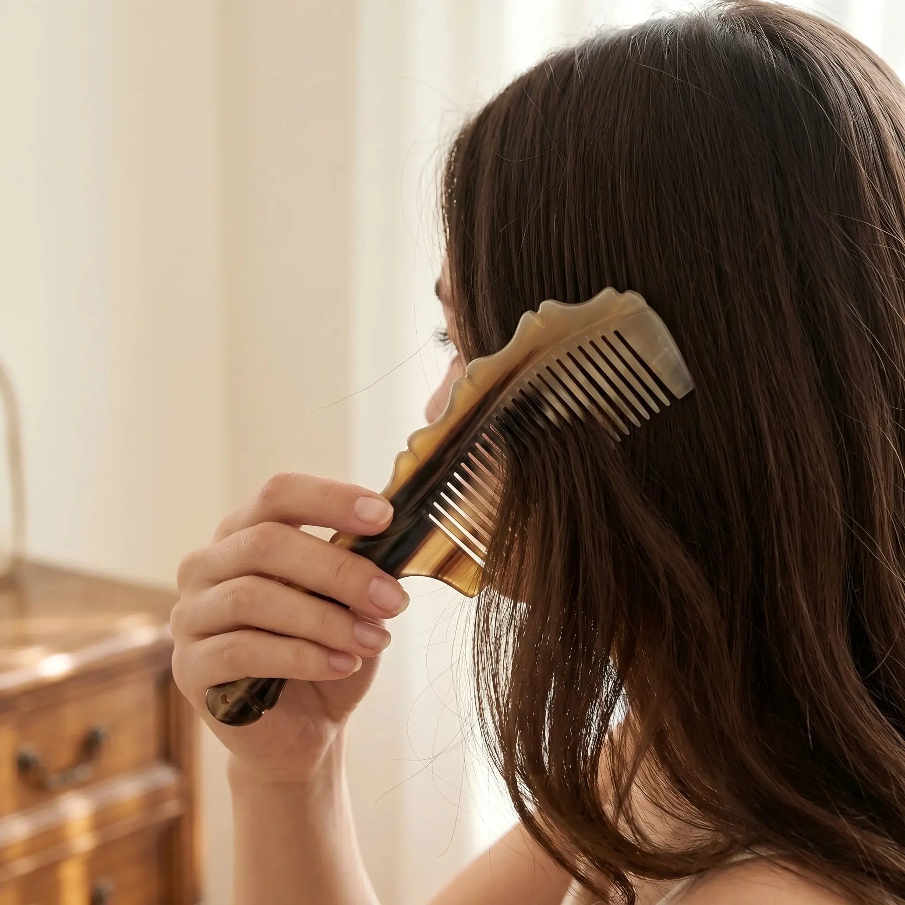 COZUY natural yak horn wave-spine comb gently combing dark hair in a daily hair-care routine. detail image 5