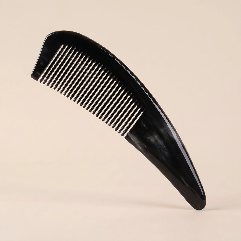An elegant Cozuy ox horn comb standing on a minimalist beige background, designed to help reduce static and smooth hair.