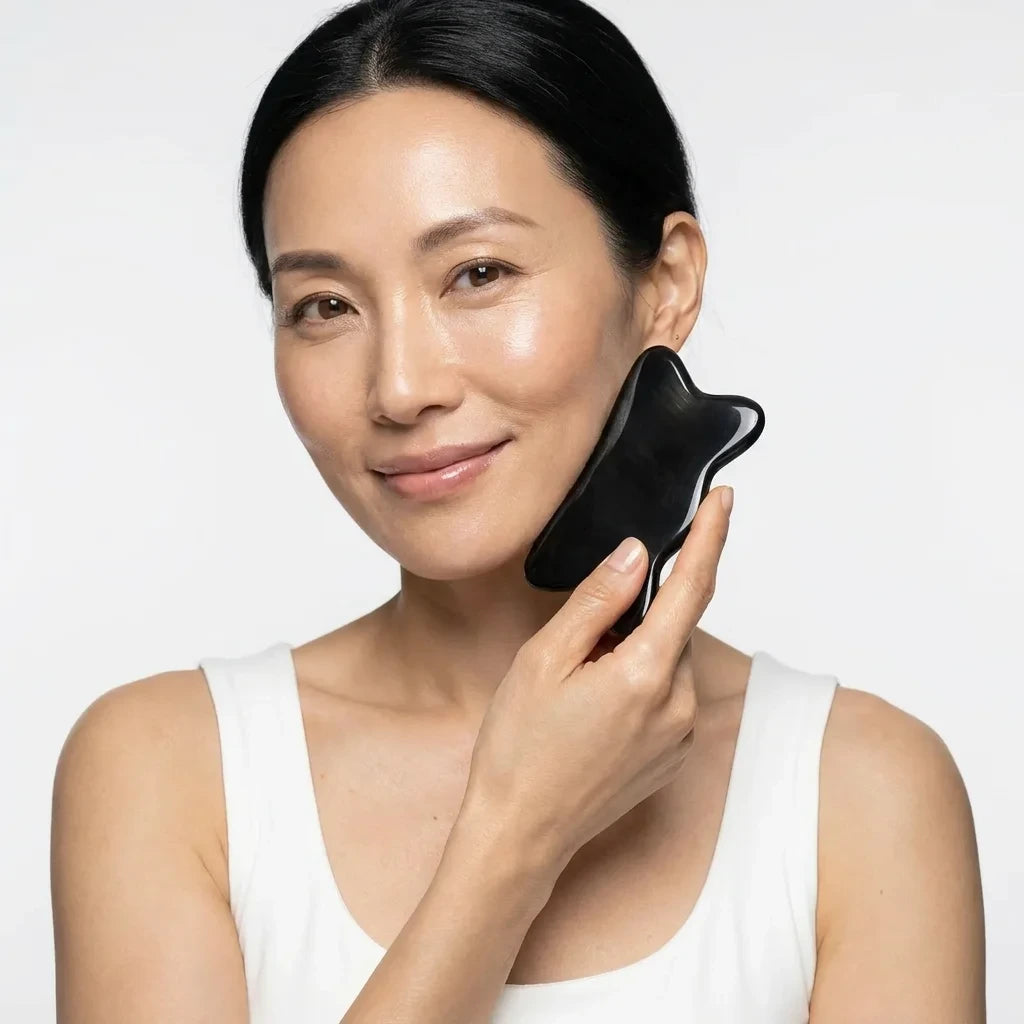 An elegant woman using a Cozuy plastic free beauty tool  during her daily ritual for a gentle massage.