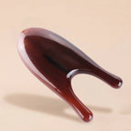 "A Cozuy scalp massage comb floating on a beige background, crafted for a mindful scalp care routine and gentle massage