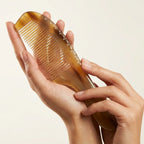 Close-up of a Cozuy scalp massage comb showing natural texture and gentle rounded teeth that massage the scalp