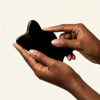 A black horn Cozuy natural beauty tool held gently in hands, serving as a mindful self care gift for women.