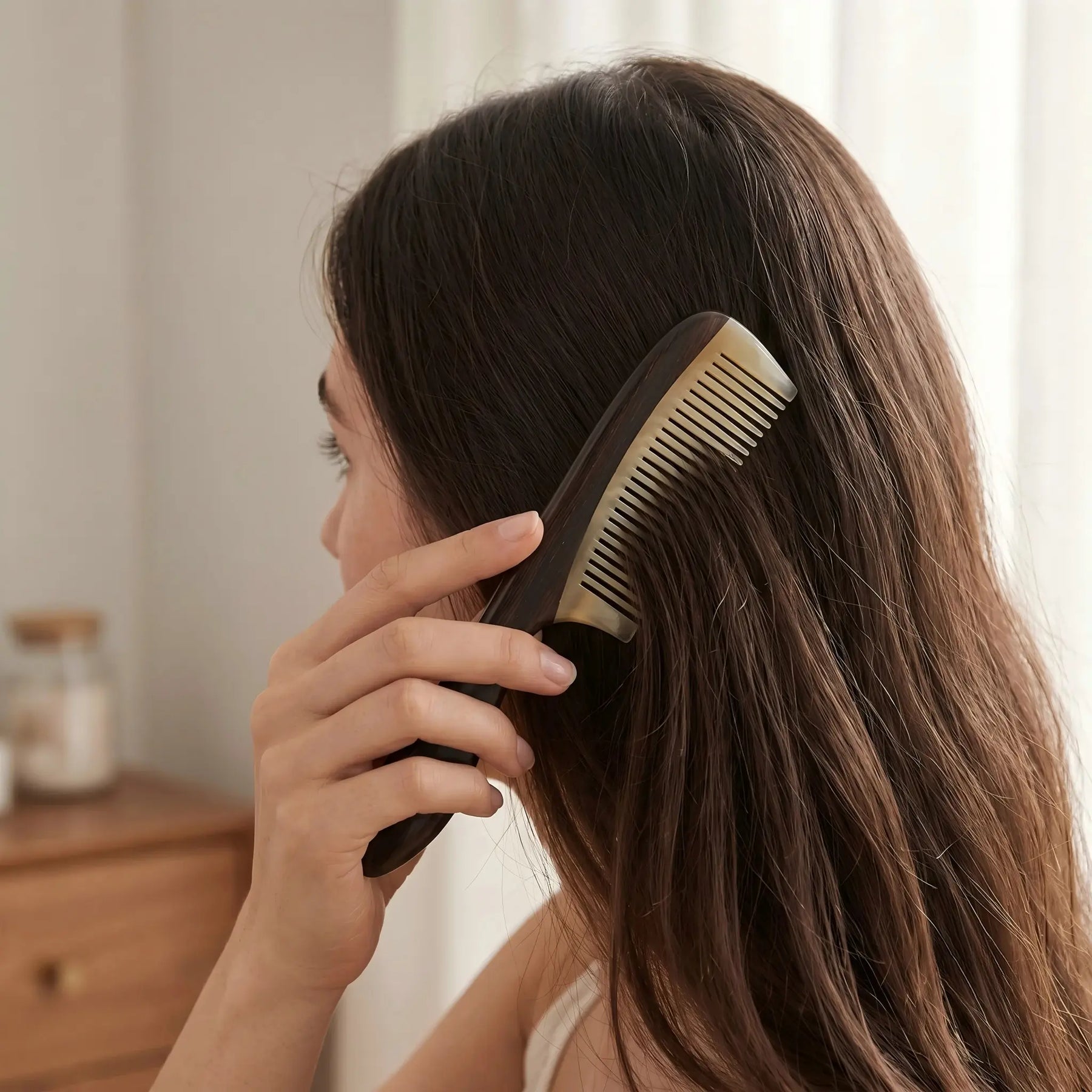 COZUY sheep horn and ebony handle comb gently combing dark hair in a daily hair-care routine. detail image 5
