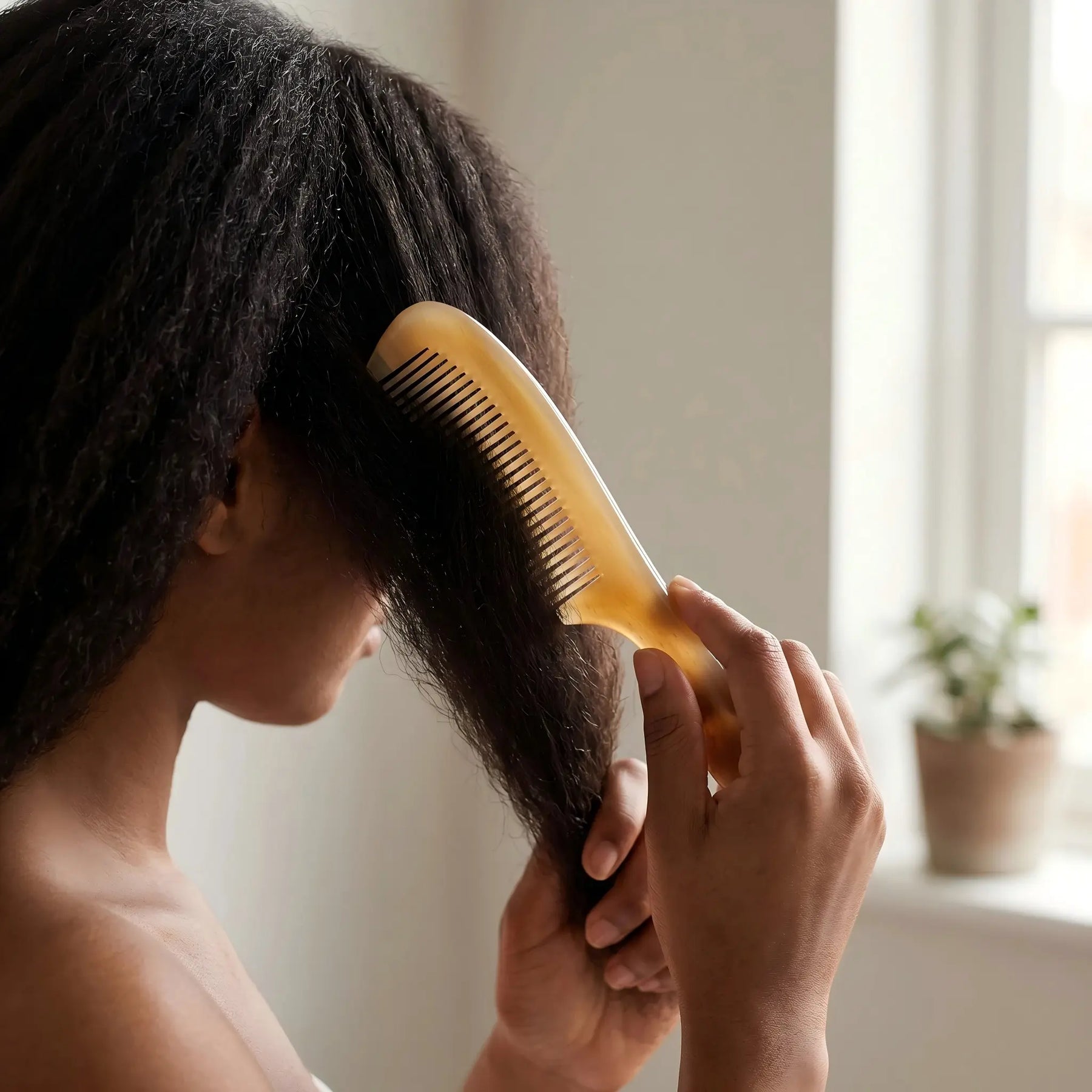COZUY translucent sheep horn handle comb gently combing straight hair in a daily hair-care routine. detail image 5