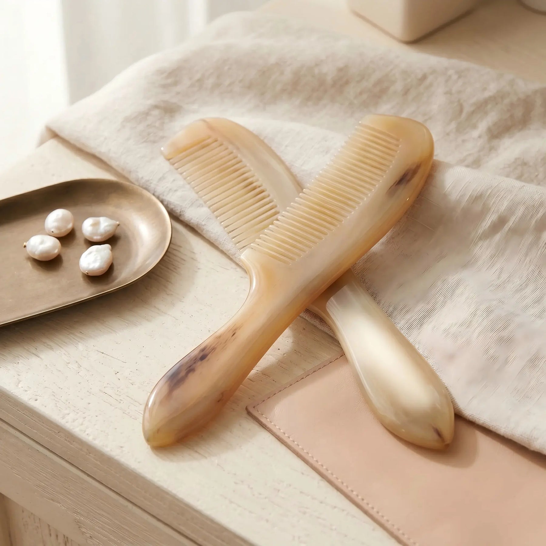 COZUY translucent sheep horn handle comb in a styled still life showing translucent color and natural horn grain. detail image 6