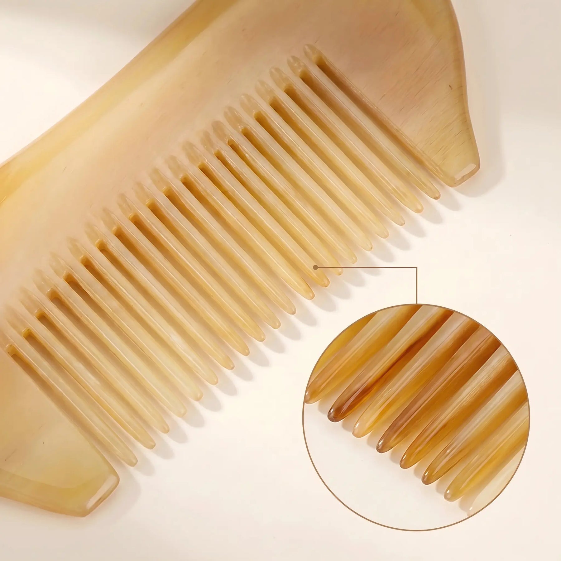 COZUY sheep horn pocket comb close-up showing translucent horn grain and polished fine teeth. detail image 2