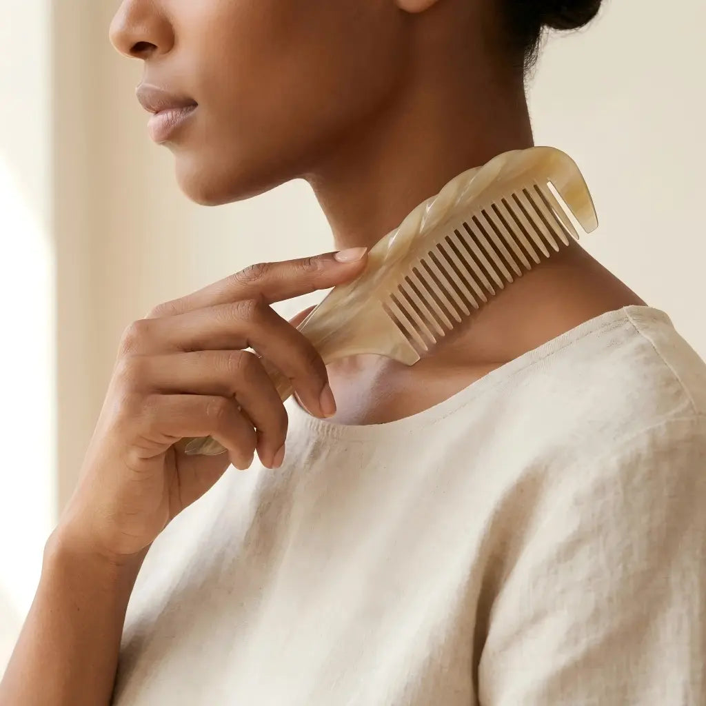 COZUY carved white yak horn comb, smooth tooth-free edge at the shoulder for a gua sha ritual. detail image 4