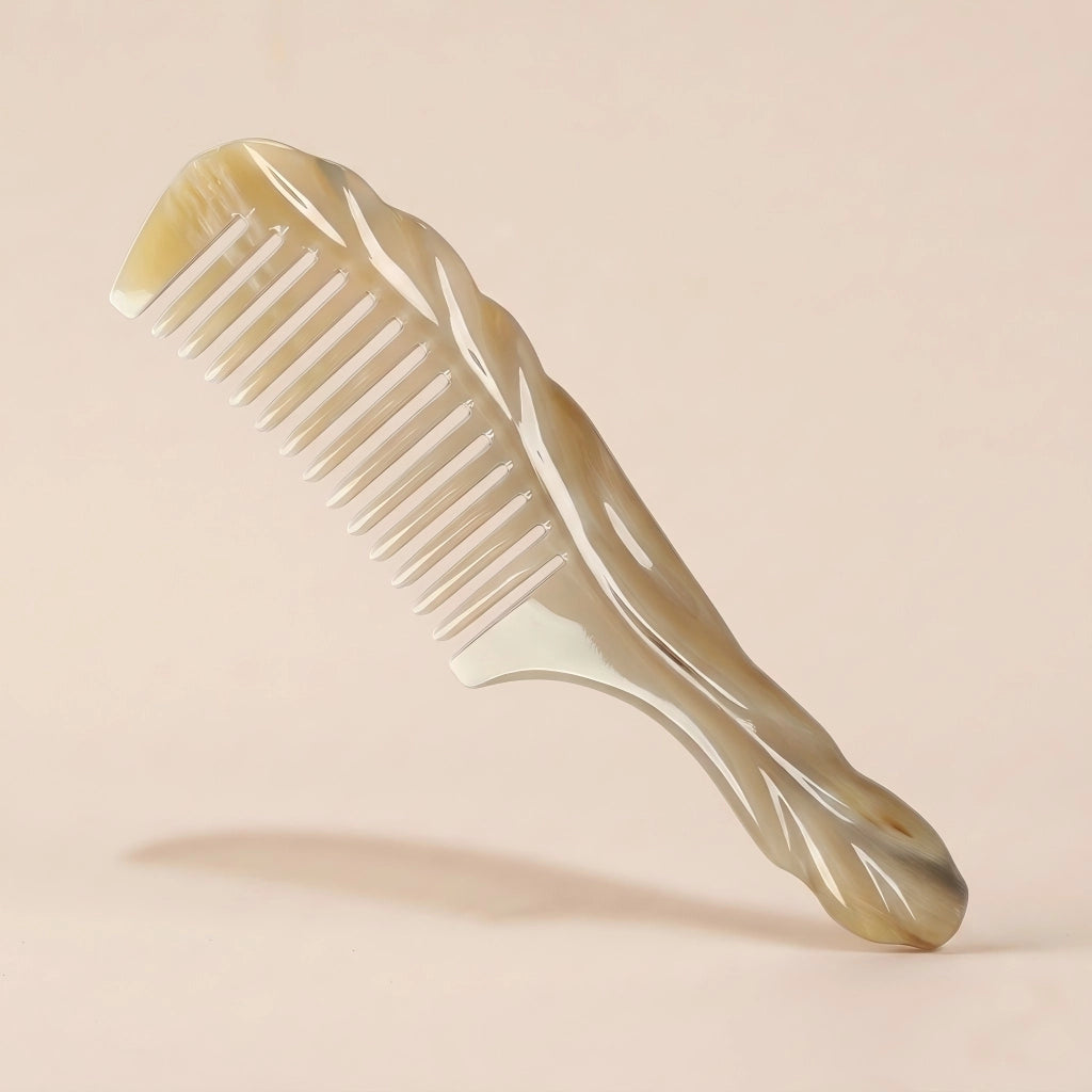 Carved white yak horn comb with a twisted handle resting on a beige background, an elegant artisan gift.