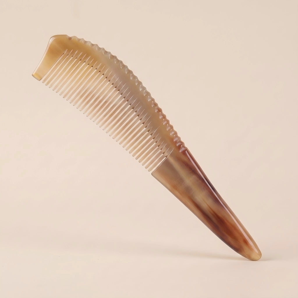 Pointed yellow buffalo horn gua sha comb floating on a beige background, an elegant tension and stress relief tool.